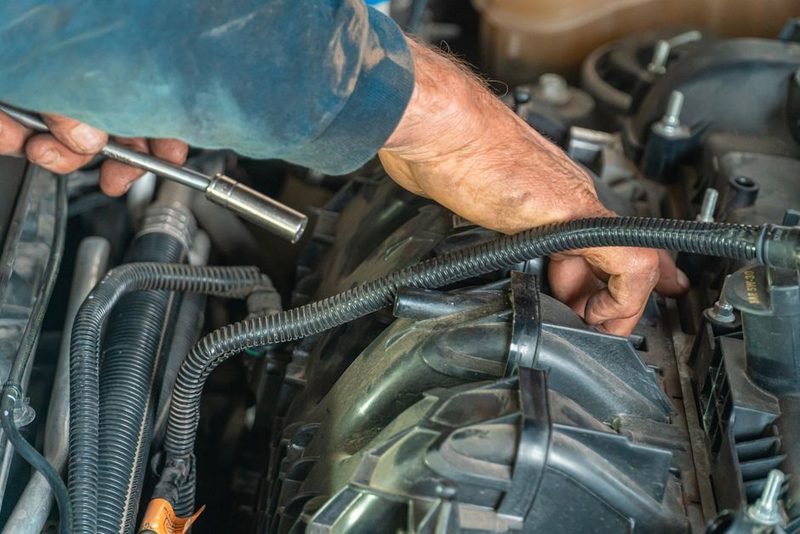 Mechanic repairing a car engine.