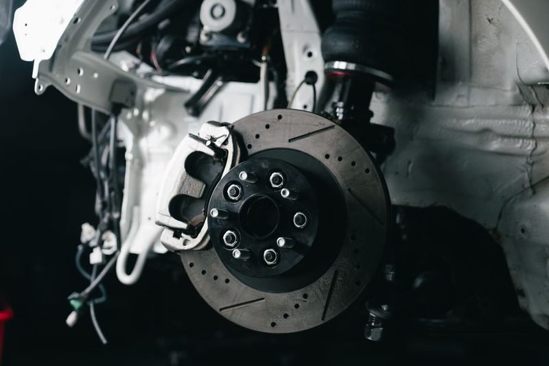 Disc brake rotor and caliper off the vehicle.