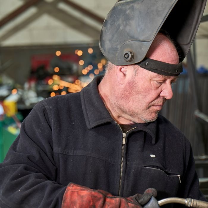 Dale Hofer with his welding helmet tipped back in the ABC Welding shop.